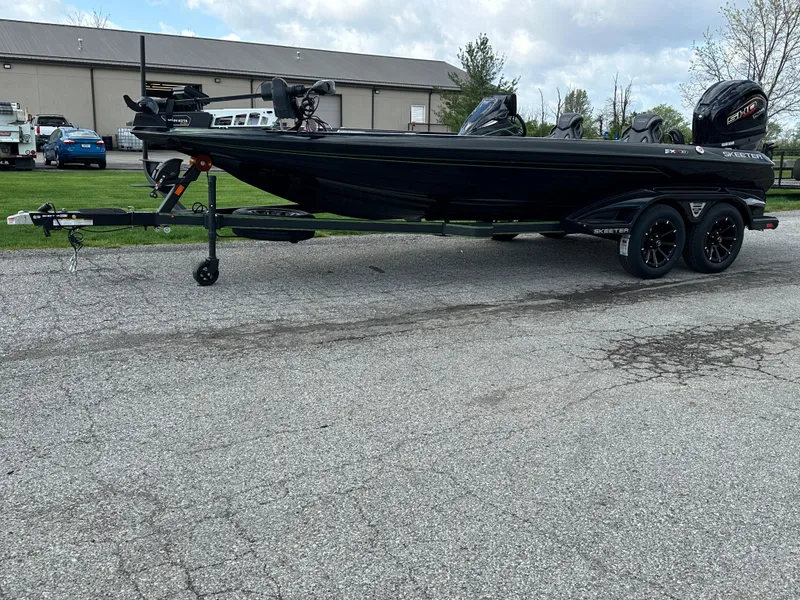 Slide: The Image of 2024 Skeeter FXR21 LE bass boat on trailer, parked outdoors. - 5