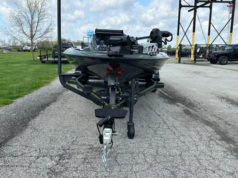 Slide: The Image of 2024 Skeeter FXR21 LE boat on trailer, parked on paved lot under cloudy sky. - 6