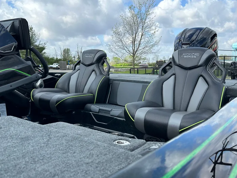 Slide: The Image of 2024 Skeeter FXR21 LE boat interior with sleek black and green seats. - 7