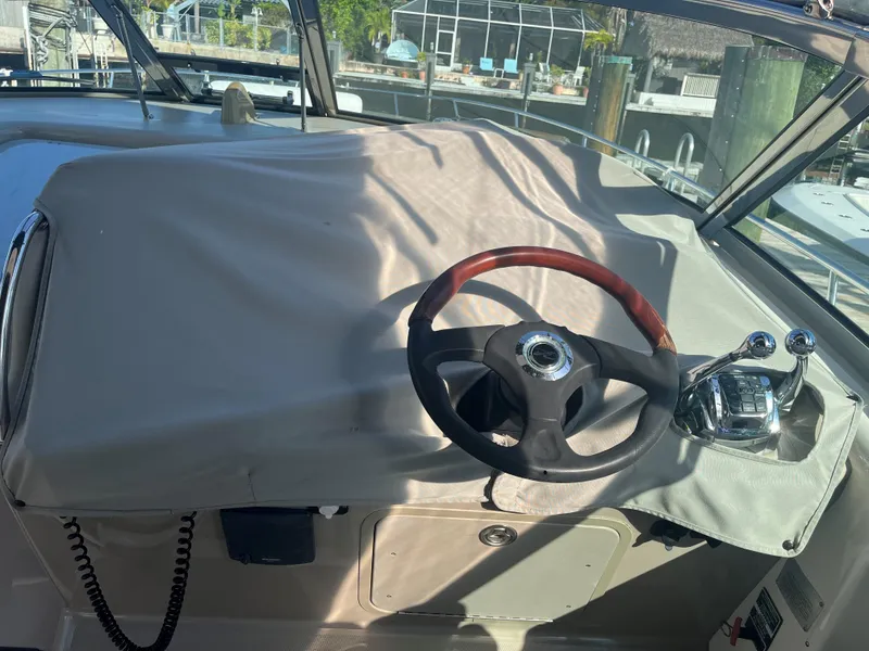 Slide: The Image of 2008 Sea Ray 340 Sundancer helm with covered dashboard and steering wheel. - 10