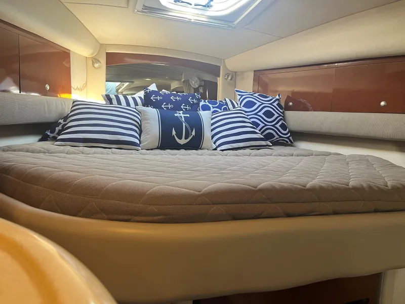 Slide: The Image of Luxurious 2008 Sea Ray 340 Sundancer cabin with nautical-themed pillows and cozy bedding. - 15