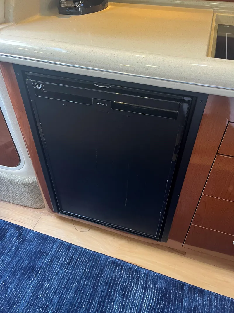 Slide: The Image of 2008 Sea Ray 340 Sundancer interior with compact black refrigerator. - 17