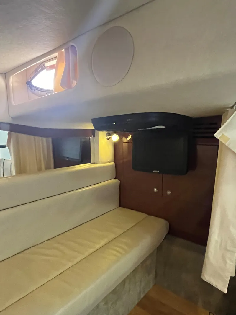 Slide: The Image of Interior of 2008 Sea Ray 340 Sundancer with beige seating and small TV. - 22