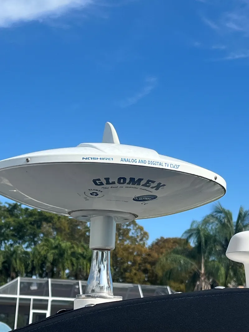 Slide: The Image of Glomex TV antenna on 2008 Sea Ray 340 Sundancer against blue sky and palm trees. - 7