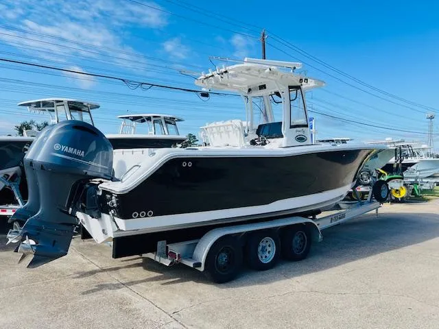 The Image of 2019 Sea Hunt Gamefish 27 boat on trailer with Yamaha engine, clear sky background. - 0