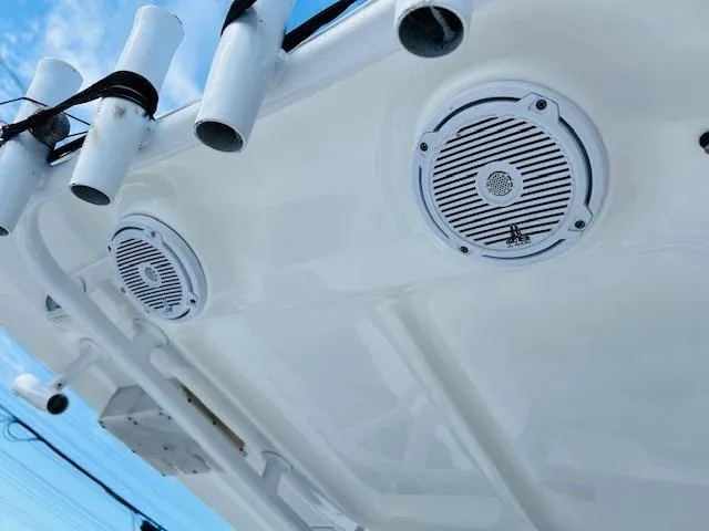 Slide: The Image of 2019 Sea Hunt Gamefish 27 boat interior with coffin box, white seating, and storage compartments. - 11