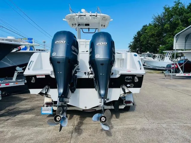 Slide: The Image of 2019 Sea Hunt Gamefish 27 boat on trailer, parked outdoors under blue sky. - 3