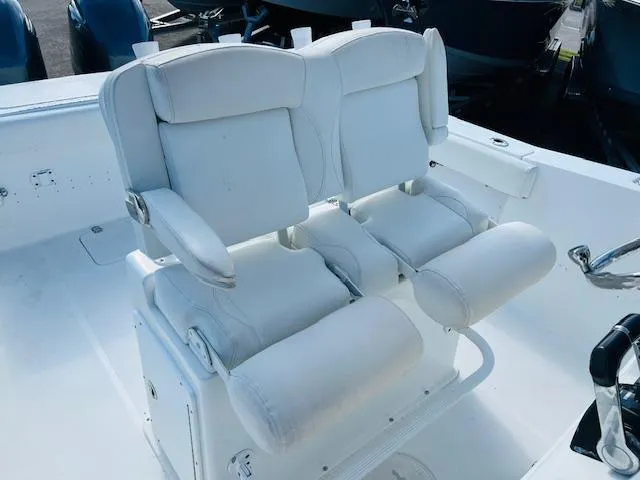 Slide: The Image of 2019 Sea Hunt Gamefish 27 boat seating with white cushioned chairs. - 7