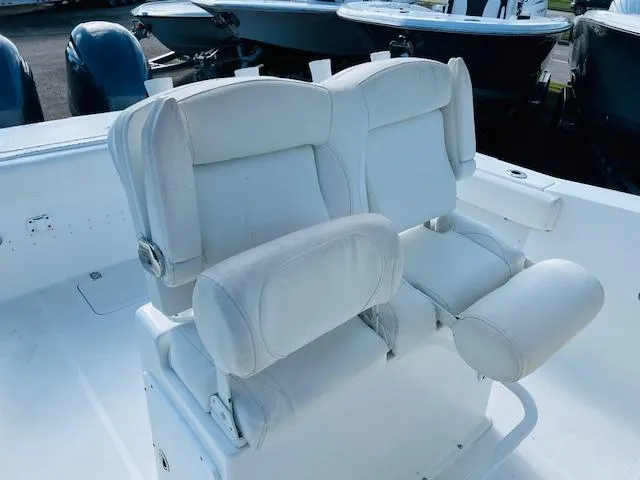 Slide: The Image of 2019 Sea Hunt Gamefish 27 dashboard with steering wheel and controls. - 8