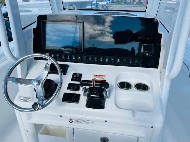 Slide: The Image of Interior view of 2019 Sea Hunt Gamefish 27 boat with control panel and windows. - 9