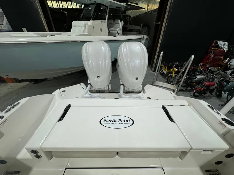 Slide: The Image of 2025 Solace 28 HCS boat with twin engines in a showroom. - 13