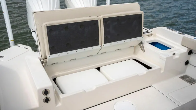 Slide: The Image of 2025 Solace 28 HCS boat seating and storage area on the water. - 8