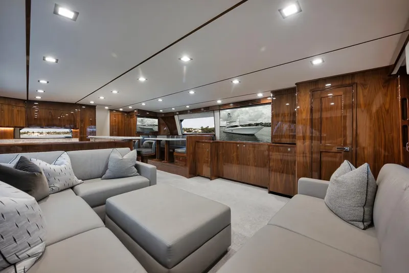 Slide: The Image of Luxurious interior of 2019 Viking 80 Convertible yacht with elegant wood finishes and plush seating. - 14