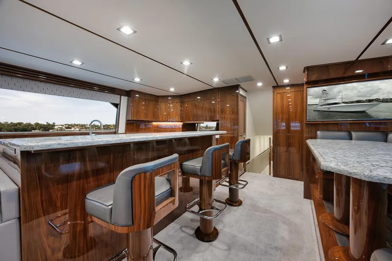 Slide: The Image of Luxurious interior of 2019 Viking 80 Convertible yacht with elegant wood finishes. - 16