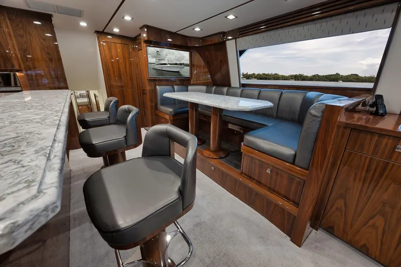 Slide: The Image of Luxurious interior of 2019 Viking 80 Convertible yacht with elegant seating and wood finishes. - 17