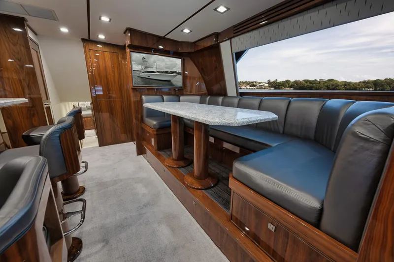 Slide: The Image of Luxurious interior of 2019 Viking 80 Convertible yacht with elegant seating and dining area. - 19