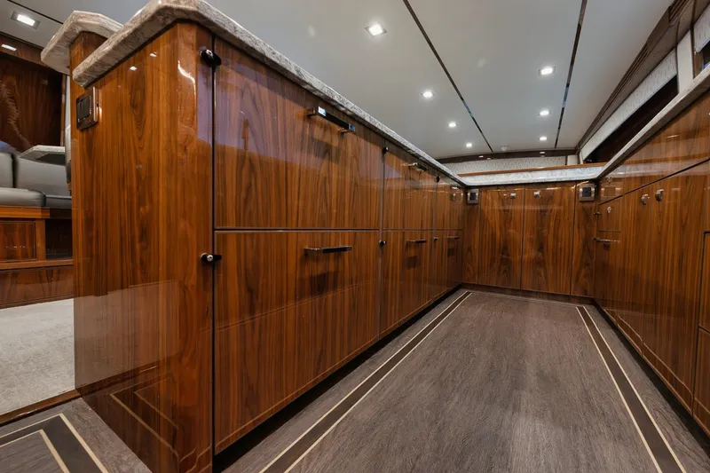 Slide: The Image of Luxurious interior of 2019 Viking 80 Convertible yacht with sleek wood cabinetry. - 21