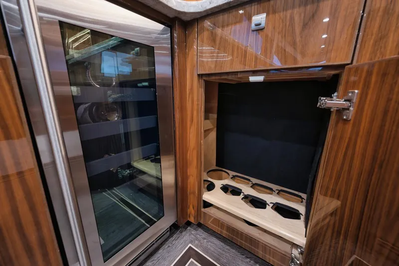 Slide: The Image of Luxurious interior of 2019 Viking 80 Convertible yacht with wood finish and wine storage. - 24