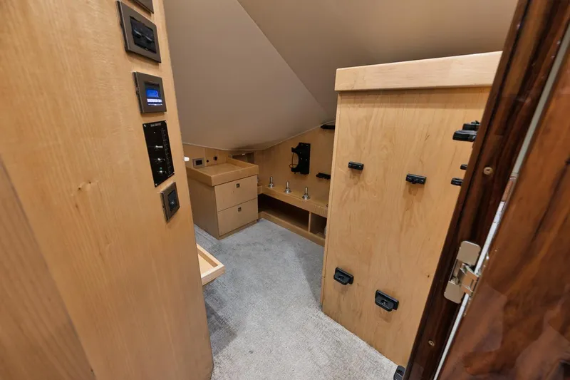 Slide: The Image of Interior of 2019 Viking 80 Convertible yacht, featuring wood cabinetry and modern controls. - 27