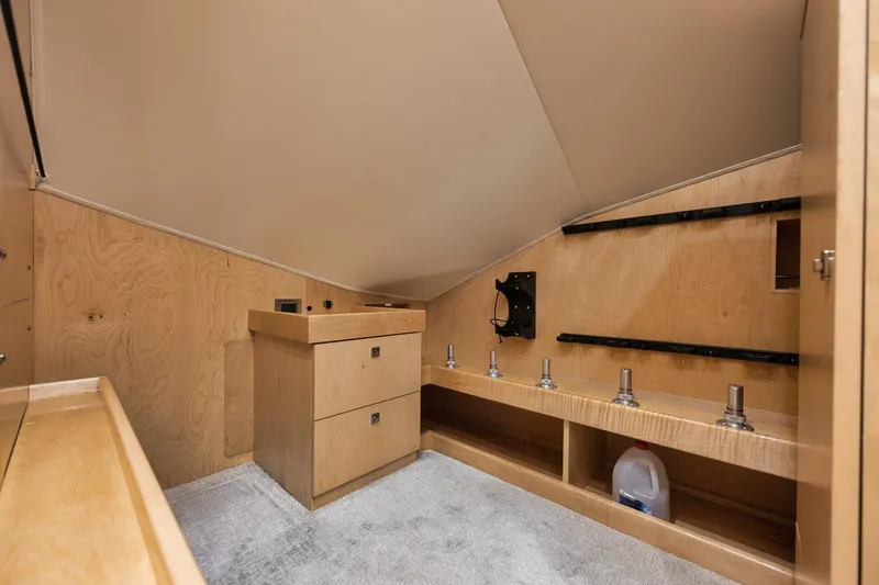 Slide: The Image of Interior of 2019 Viking 80 Convertible yacht with wooden cabinetry and storage space. - 28