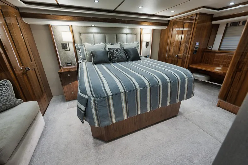 Slide: The Image of Luxurious bedroom interior of 2019 Viking 80 Convertible yacht with striped bedding. - 29