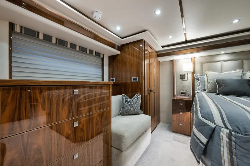 Slide: The Image of Luxurious interior of 2019 Viking 80 Convertible yacht bedroom with wood finishes. - 31
