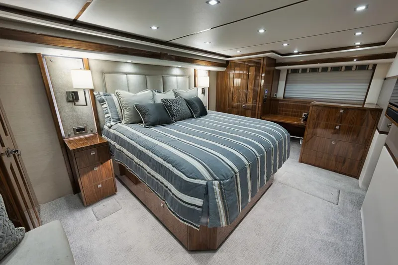 Slide: The Image of Luxurious bedroom interior of 2019 Viking 80 Convertible yacht with striped bedding. - 32