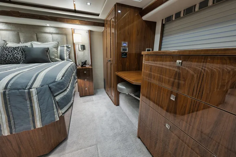 Slide: The Image of Luxurious interior of 2019 Viking 80 Convertible yacht bedroom with wood finishes. - 35