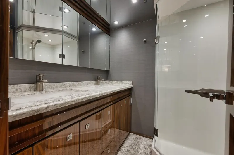 Slide: The Image of Luxurious bathroom in 2019 Viking 80 Convertible yacht with marble countertop and glass shower. - 38