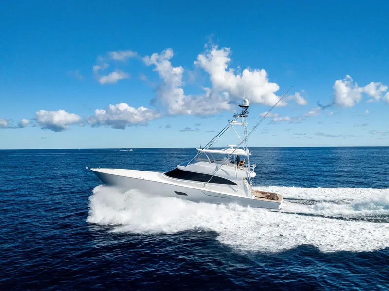 Slide: The Image of 2019 Viking 80 Convertible yacht cruising on open ocean under blue sky. - 4