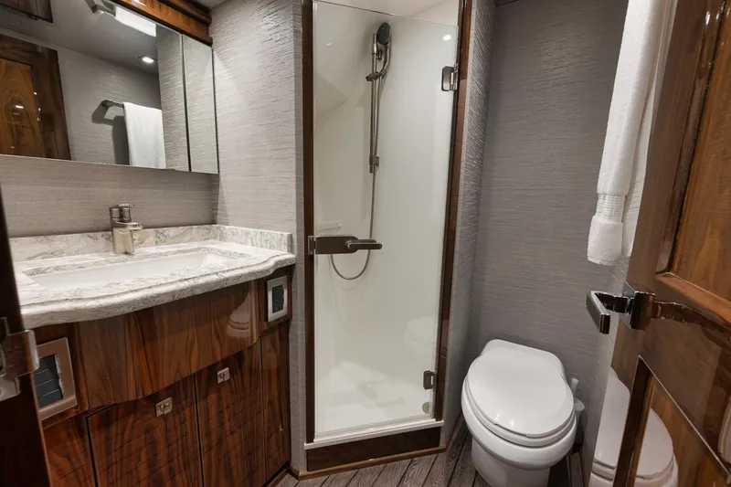 Slide: The Image of Luxurious bathroom in 2019 Viking 80 Convertible yacht with shower, toilet, and vanity. - 41