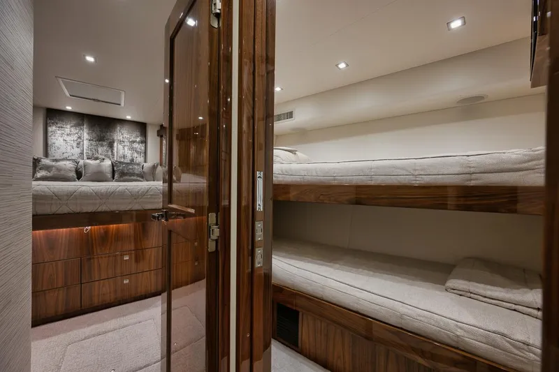 Slide: The Image of Luxurious 2019 Viking 80 Convertible yacht interior with cozy bunk beds. - 44