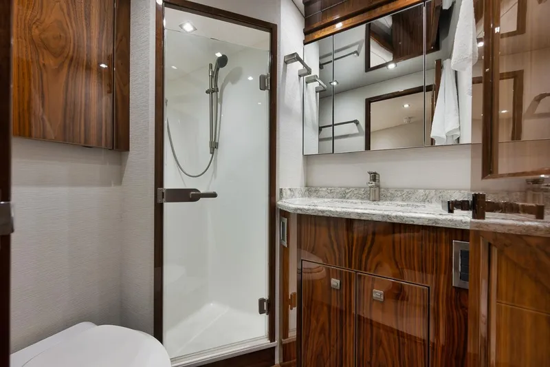 Slide: The Image of Luxurious bathroom in 2019 Viking 80 Convertible yacht with wood accents and modern fixtures. - 45