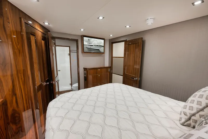 Slide: The Image of Luxurious bedroom interior of 2019 Viking 80 Convertible yacht with wood accents. - 48