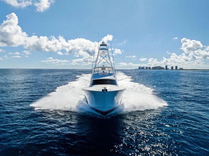 Slide: The Image of 2019 Viking 80 Convertible yacht cruising on open ocean under clear blue sky. - 5