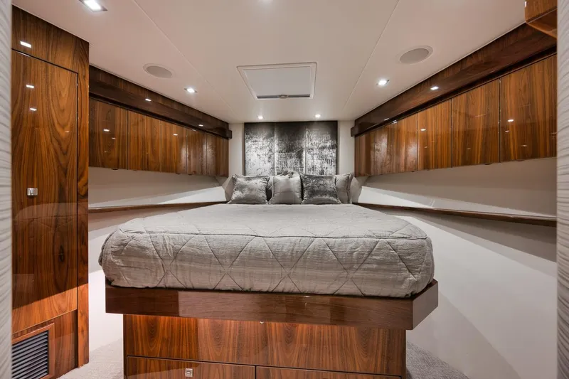 Slide: The Image of Luxurious bedroom interior of 2019 Viking 80 Convertible yacht with wood paneling. - 51