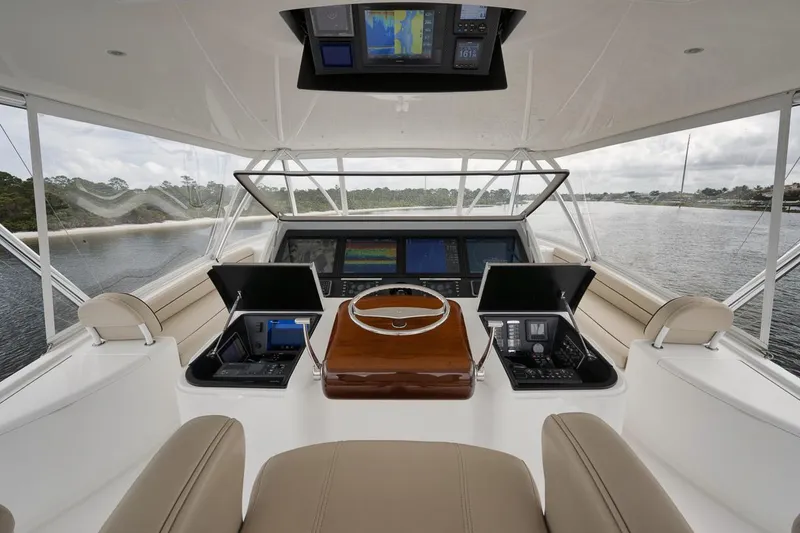Slide: The Image of 2019 Viking 80 Convertible yacht helm with advanced navigation systems and panoramic water views. - 56