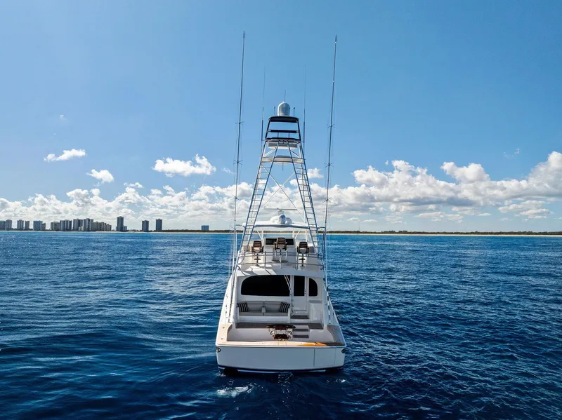 Slide: The Image of 2019 Viking 80 Convertible yacht on open sea with city skyline. - 7