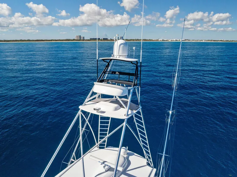 Slide: The Image of 2019 Viking 80 Convertible yacht on open sea with clear blue skies. - 8