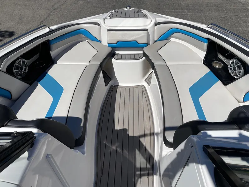 Slide: The Image of 2018 Yamaha Boats 242X E-Series interior with blue and white seating, sleek design. - 10