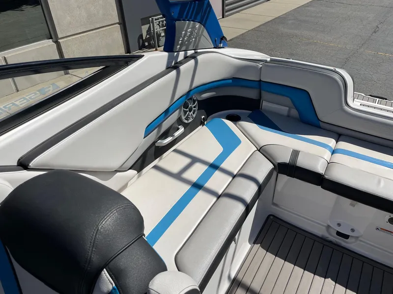Slide: The Image of 2018 Yamaha Boats 242X E-Series interior with blue and white seating. - 6