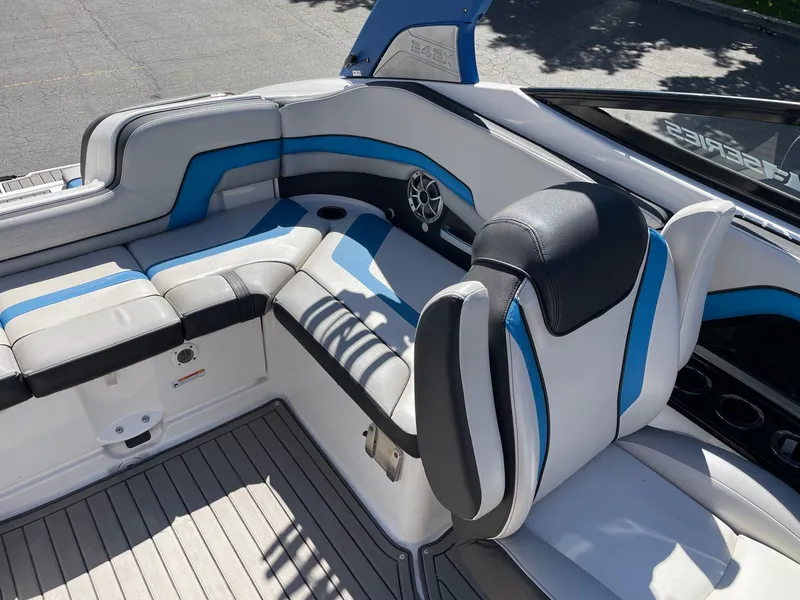 Slide: The Image of 2018 Yamaha Boats 242X E-Series interior with blue and gray seating. - 8