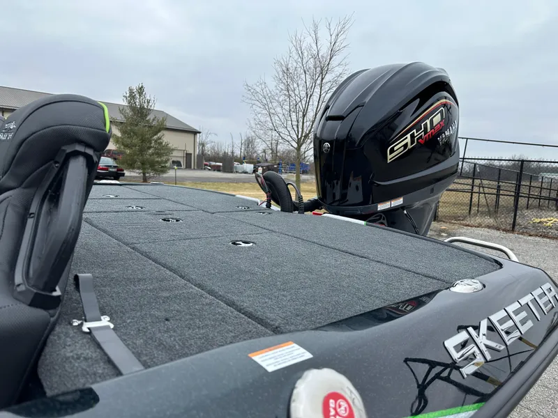 Slide: The Image of 2024 Skeeter ZXR19 boat with powerful engine, parked outdoors. - 12