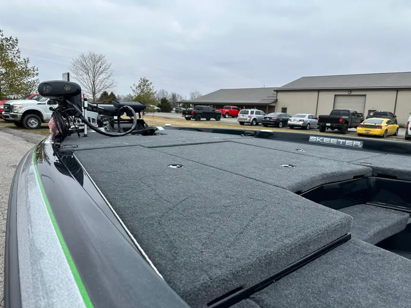 Slide: The Image of 2024 Skeeter ZXR19 boat with spacious deck, parked outdoors. - 15