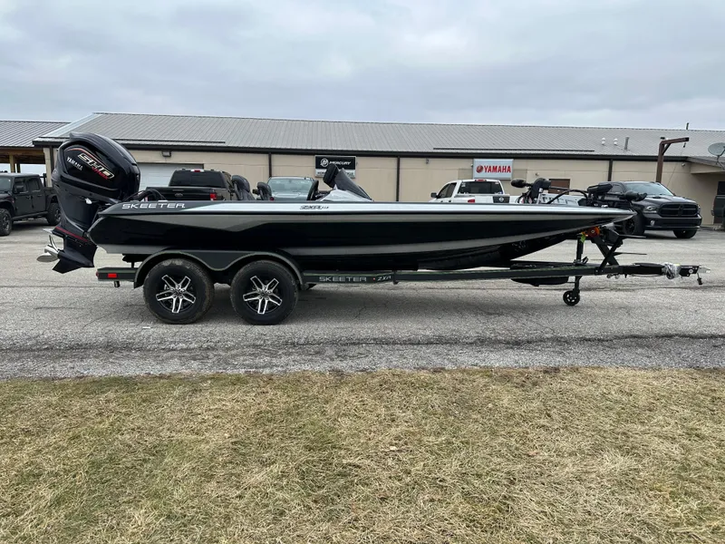 Slide: The Image of 2024 Skeeter ZXR19 boat on trailer, parked outdoors near a building. - 5