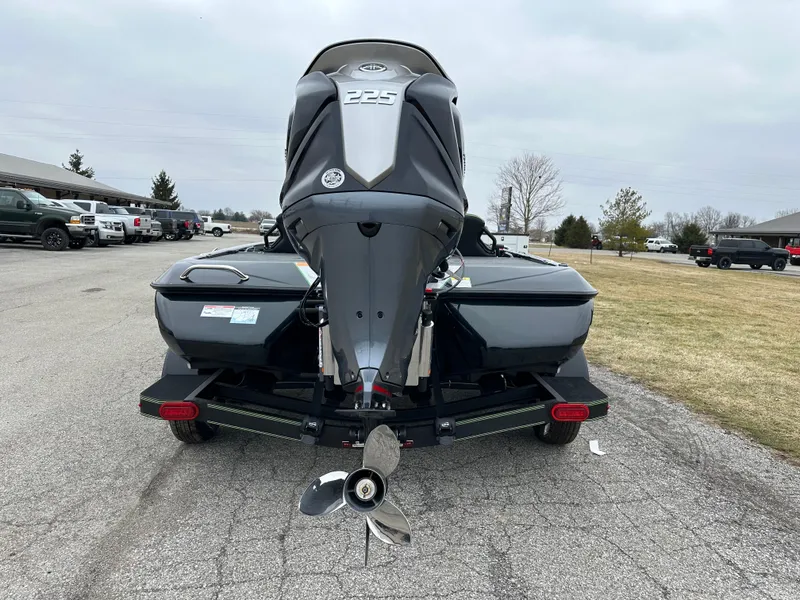 Slide: The Image of 2024 Skeeter ZXR19 boat with powerful 225 engine, parked on a paved area. - 8
