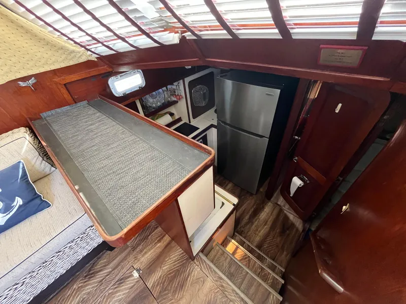 Slide: The Image of Interior of 1980 Gulfstar Trawler with kitchen, fridge, and wooden flooring. - 12