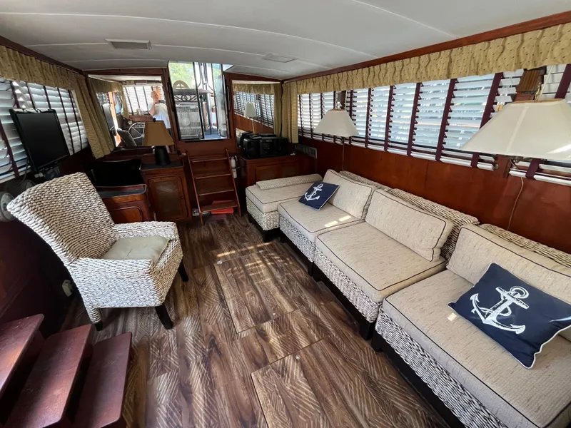 Slide: The Image of Interior of 1980 Gulfstar Trawler with cozy seating and nautical decor. - 13