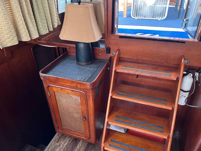 Slide: The Image of Interior of 1980 Gulfstar Trawler with wooden stairs and lamp. - 34