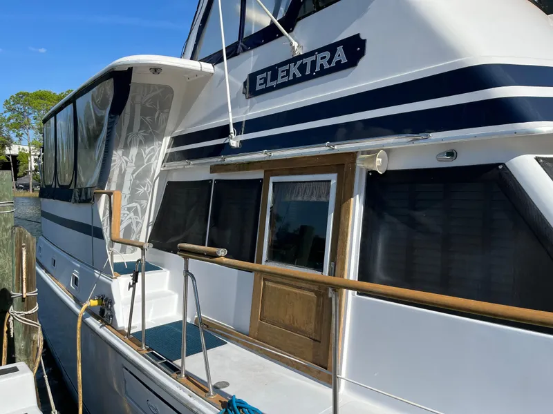 Slide: The Image of 1980 Gulfstar Trawler "Elektra" docked, featuring a classic design and wooden accents. - 4